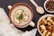 Savory cream soup with mushrooms in porcelain bowl on kitchen towel