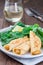 Savory crepe with shrimps and creamy dill sauce served with green leaves salad and lemon, vertical