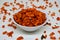 Savory and crunchy spicy macaroni in a bowl on a white background.