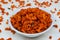 Savory and crunchy spicy macaroni in a bowl on a white background.