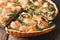 Savory food: sliced tart with salmon, spinach and cream close-up. horizontal