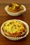 Savory mini quiches tarts on a wooden board. Baked homemade flaky dough pies. Ready for eat. Copy space