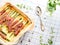 Savory quiche pie with asparagus, prosciutto and marjoram