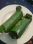 Savory roasted rice wrapped in banana leaves