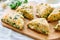 Savory scones with feta and mozarella and green herbs on a woode