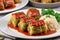 Savory Stuffed Cabbage with Rice: Delectable Dish on a White Table.