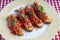 Savory tomato-based Italian appetizers or bruschetta on toasted basil baguette slices