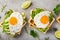 Savory waffles with avocado, arugula and fried egg for breakfast