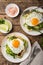 Savory waffles with avocado, arugula and fried egg for breakfast