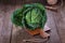 Savoy cabbage over wooden background