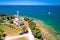 Savudrija lighthouse and turquoise crystal clear rocky beach aerial view