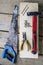 Saw - hacksaw, pliers, screws, hammer, nails - on a bar and wooden unplaned boards