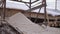 Sawdust pile on lumber logs stack with markers at sawmill