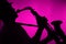 Saxophone Played in Silhouette Pink Background