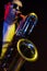 Saxophonist Guy in Sunglasses Plays the Tenor Saxophone, Musician Blows the Saxophone. Selective Focus on Bell of
