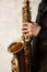saxophonist holding alto saxophone, hands on the keys of the instrument, jazzman