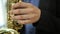 Saxophonist musician playing saxophone or sax at party. selective focus