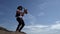 Saxophonist is playing melody, standing against blue sky, music and nature