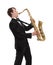 Saxophonist in a tuxedo plays music on sax.