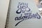 Say Yes to New Adventures calligraphic background