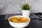 Sayur asem is a popular Indonesian vegetable in tamarind soupâ€Ž with jack fruit, corn, long beans in a white bowl in a kitchen.