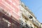 Scaffolding fragment of a scaffolded house wall in street