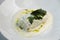 Scalding hot baked cabbage rolls with cream sauce close-up. Restaurant serving of cabbage rolls on a plate with greens