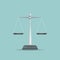 Scales of justice icon on blue background.