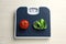 Scales with tomato and measuring tape on white wooden table, top view. Weight loss