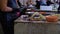 Scaling and Cutting Fish in Market Stall. Woman Manual cleaning and Cuts Fresh Fish