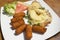 Scalloped turkey steak with cheese, ananas and croquette