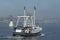 Scalloper Discovery II crossing foggy New Bedford inner harbor
