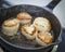 Scallops cooking in cast iron pan