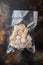 Scallops in vacuum pack, top view, on old rustic background