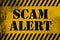 Scam alert sign yellow with stripes