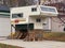 A Scamper truck campers in a garage