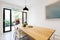 Scandi styled dining room interior with outlook to courtyard via