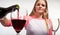 Scandinavian cute young girl pouring her glass with red wine