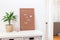 Scandinavian style home interior with a white shelves, green palm in  pot, and pegboard with the inspiring phrase, minimalistic