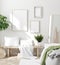 Scandinavian style white fresh bedroom interior with mockup frames on wall