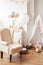 Scandinavian style white interior children`s room, bedroom, nursery. Baby cot with canopy. Wooden shelves and toys. Canopy tent,