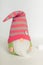 Scandinavian Swedish gnome in green clothes and pink hat with a deer on a white background