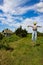 Scarecrow in apple orchard with blue sky