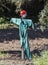 Scarecrow made with green work overalls and rags