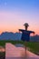 Scarecrow or strawman in the shape of a human. It dresses old shirt and made from rice straw. Photo scene is mountains, rice field