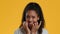 Scared Black Teenager Girl Biting Fingernails In Fear, Yellow Background
