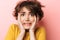 Scared confused beautiful woman posing isolated over pink wall background