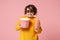 Scared dissatisfied young woman in 3d imax glasses posing isolated on pink background. People in cinema, lifestyle