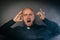 Scared frightened catholic priest in black shir