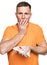 Scared man looking at a bloody napkin over white background